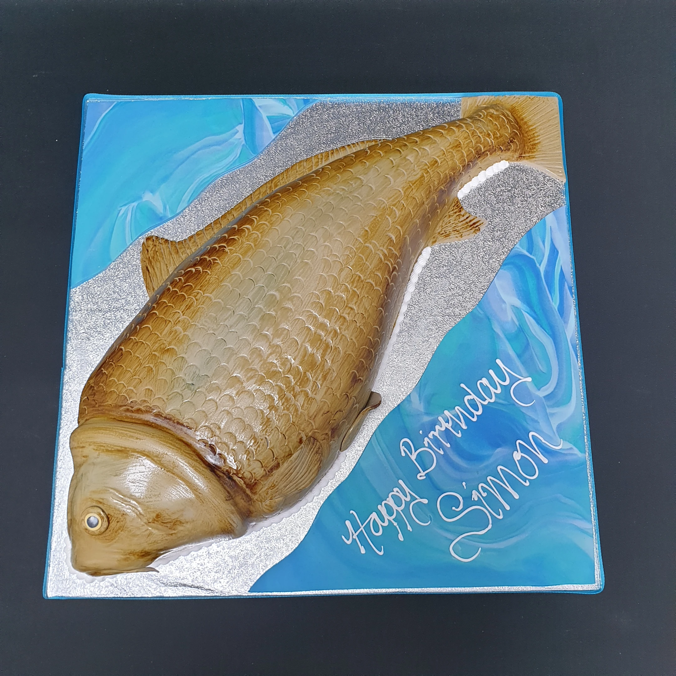 Bespoke carp fish cake with detailed scales and fins, crafted for a celebration in Solihull, West Midlands.