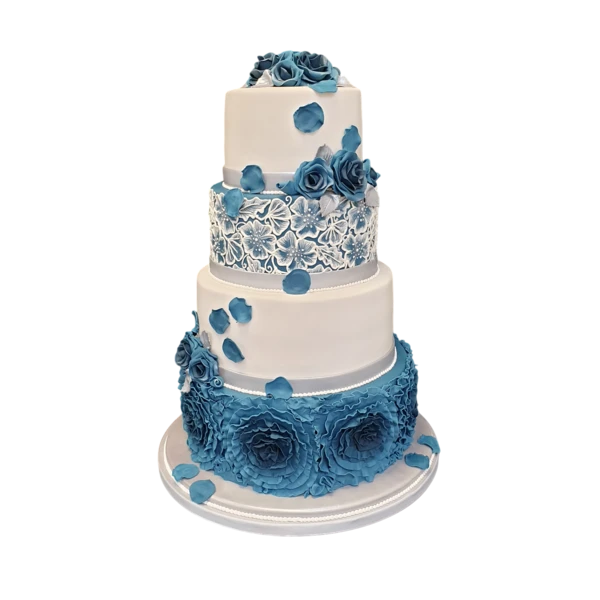 Four-tier white wedding cake with blue sugar paste roses and lace detailing.