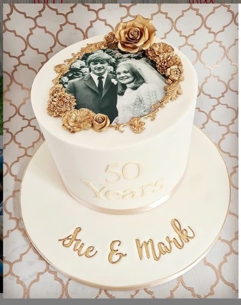 Bespoke celebration cake with intricate floral icing and gold accents, crafted in Solihull, West Midlands.