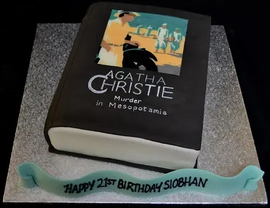 Bespoke cake shaped like an Agatha Christie book with detailed cover art, crafted in Solihull, West Midlands.