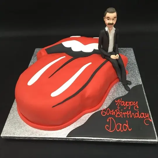 Bespoke Rolling Stones tongue cake with vibrant red and white icing, crafted for celebration in Solihull, West Midlands.
