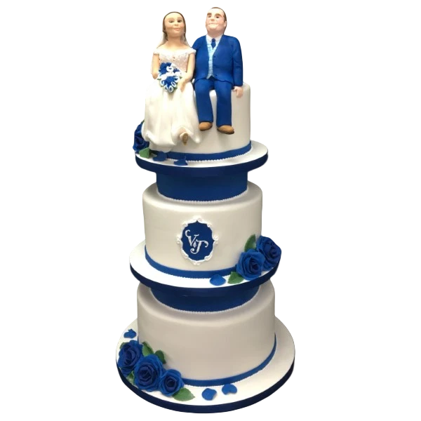 Three-tier wedding cake with blue sugar paste roses and couple figurines.
