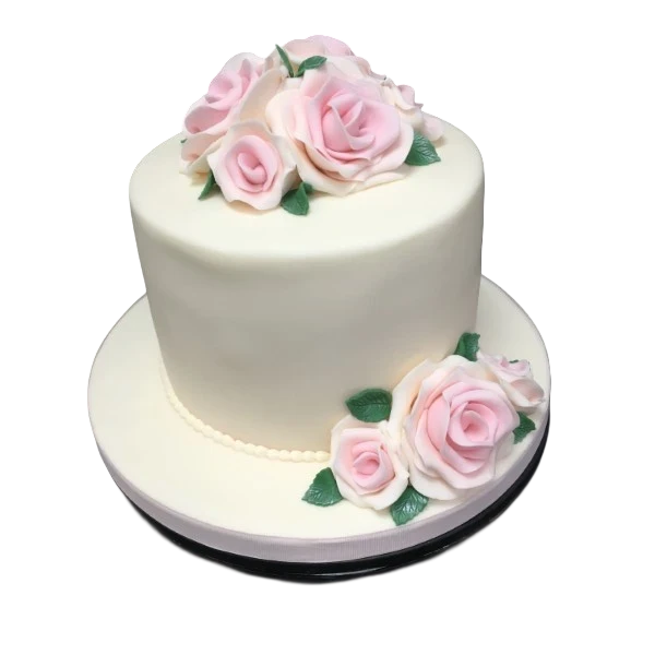 Beautifully decorated cake with intricate designs and delicate roses on top, perfect for special occasions or celebrations.