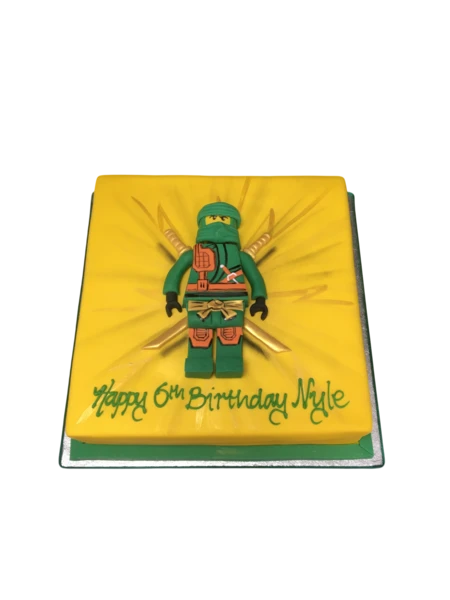 Bespoke LEGO NINJAGO celebration cake with colorful ninja figures and brick details in Solihull, West Midlands.
