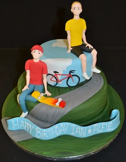 Bespoke celebration cake featuring cyclist and skateboarder figures, crafted in Solihull, West Midlands.