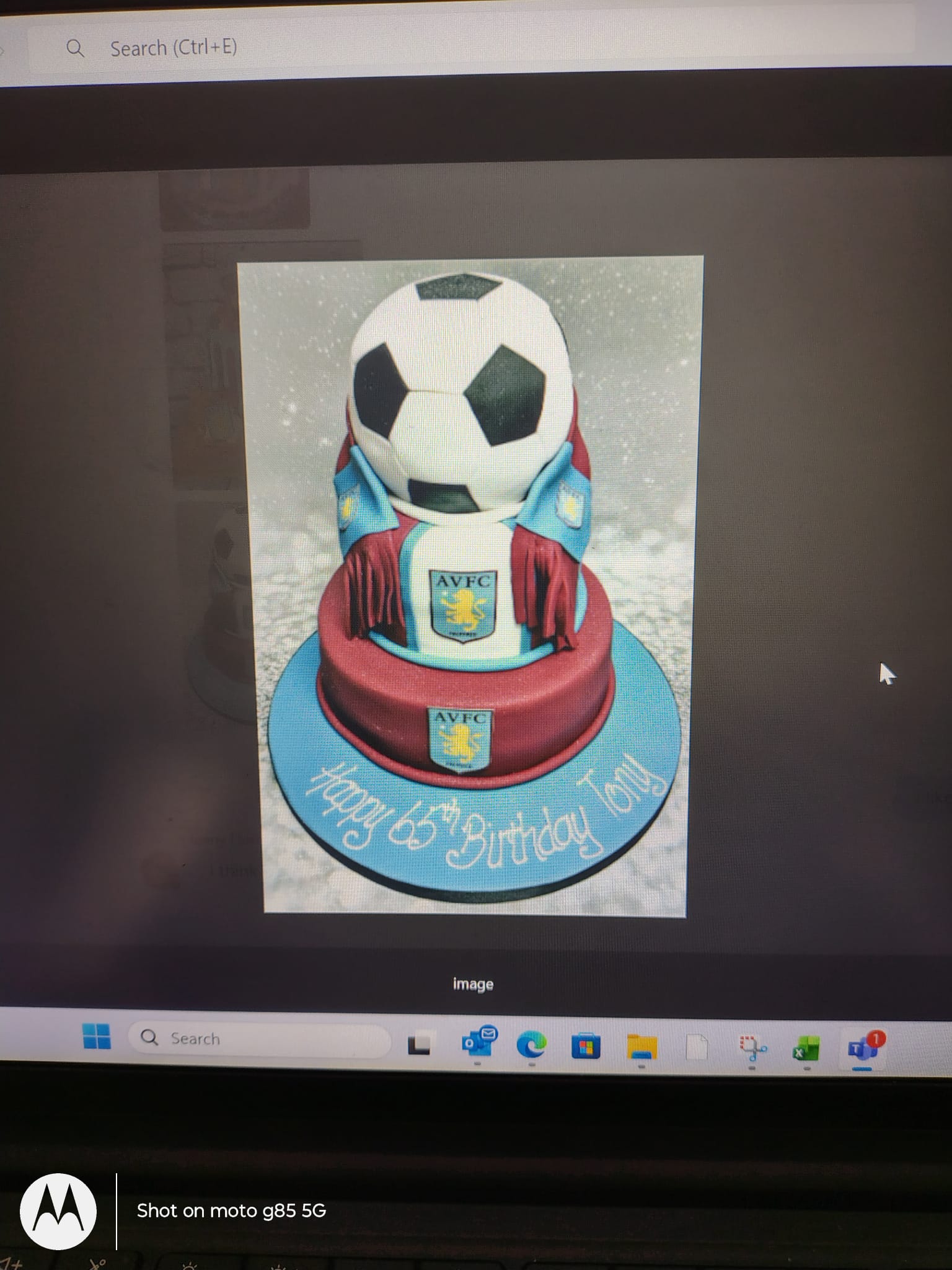 Bespoke celebration cake with colorful icing and decorative swirls, crafted in Solihull, West Midlands.