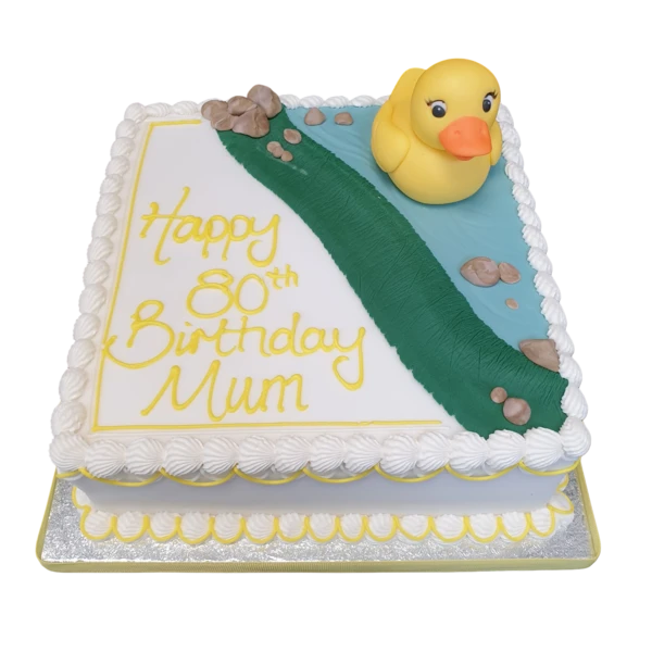 Bespoke celebration cake shaped like a yellow rubber duck with blue water waves, made in Solihull, West Midlands.
