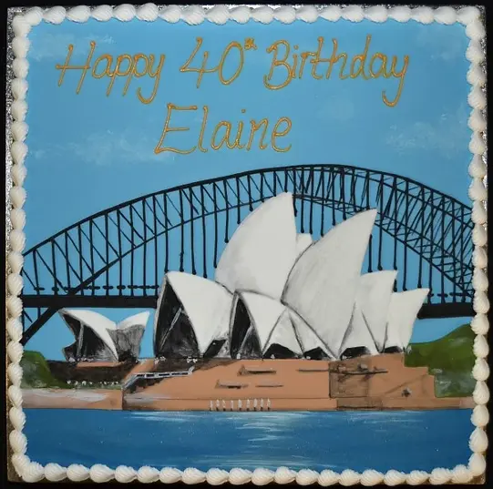 Bespoke cake shaped like Sydney Opera House with white sails, detailed structure, in Solihull, West Midlands celebration.