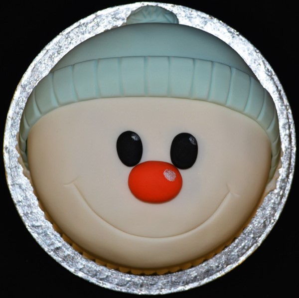 Festive snowman Christmas cake with decorative icing and holiday-themed design, perfect for seasonal celebrations and adding a touch of winter charm to your dessert table.