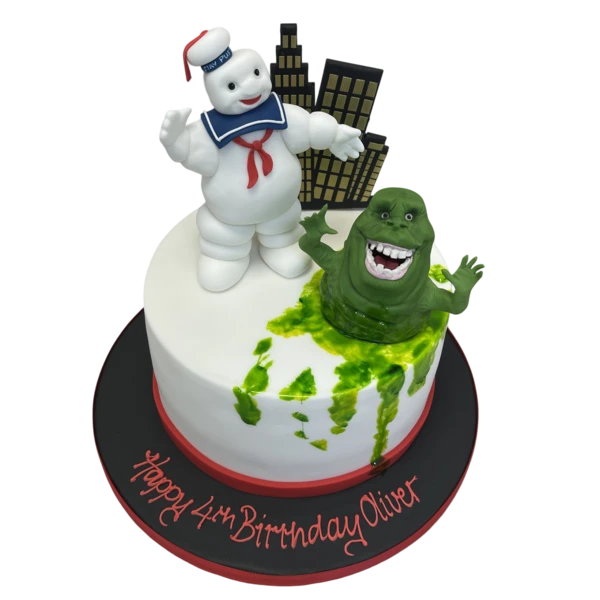 A spooky Halloween-themed cake featuring a Ghostbusters Slimer and Stay Puft design, perfect for themed parties and celebrations.