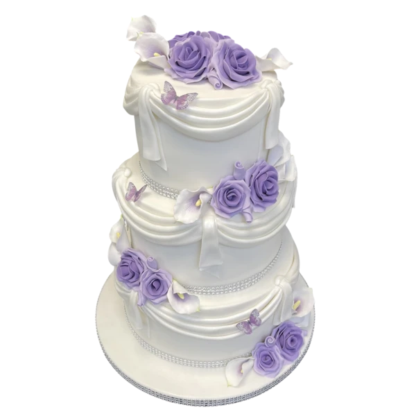 Three-tier wedding cake with lavender roses, sugar paste drapes, and butterflies.