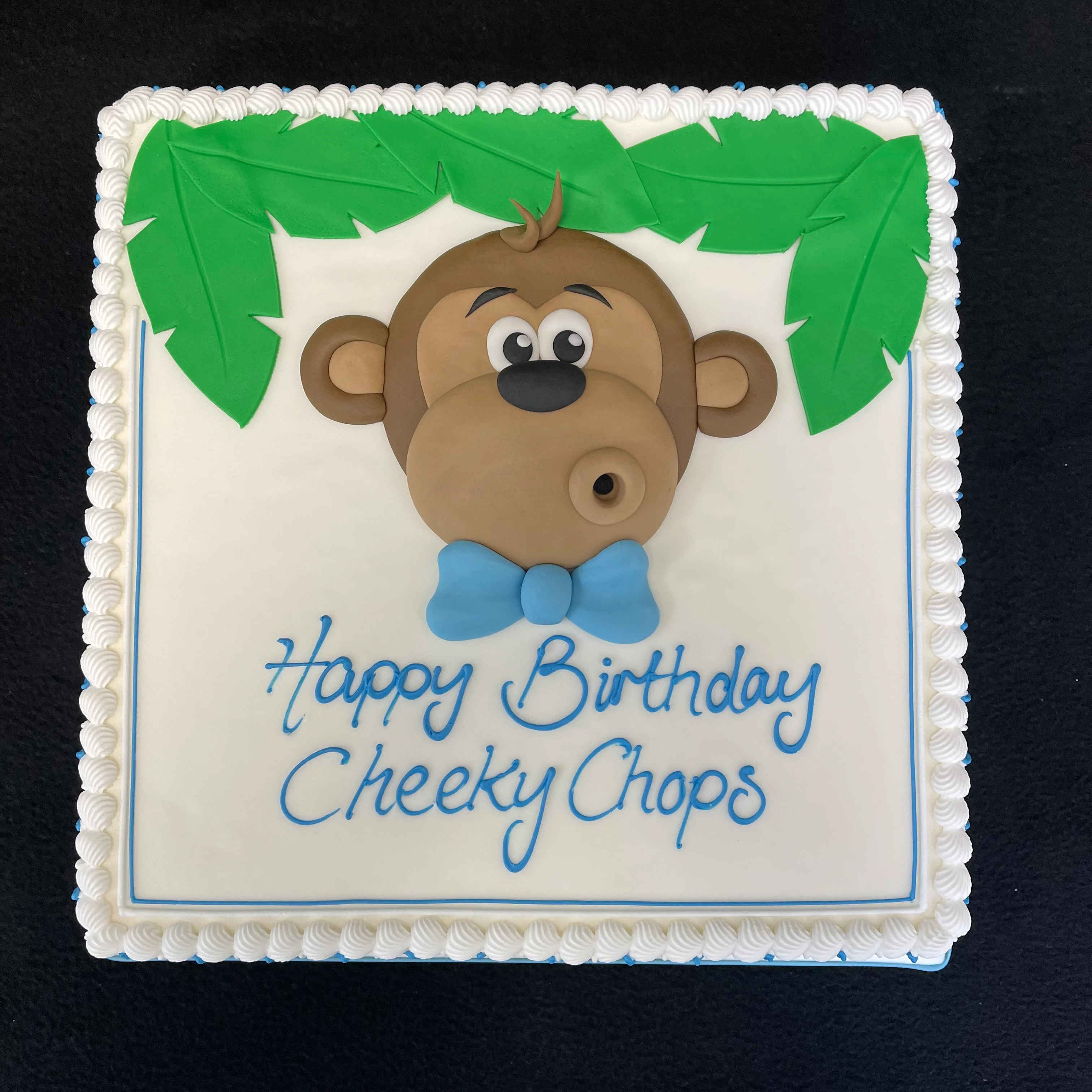 Adorable cheeky chops monkey head cake for a fun celebration, with intricate detailing and a playful design, perfect for parties and special occasions in UK.