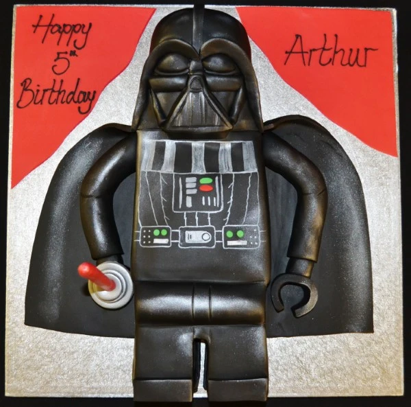 A creative and fun LEGO Darth Vader themed cake with intricate details, perfect for fans of the iconic Star Wars villain.