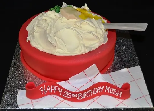 Bespoke celebration cake shaped like mashed potatoes with textured white icing, crafted in Solihull, West Midlands.