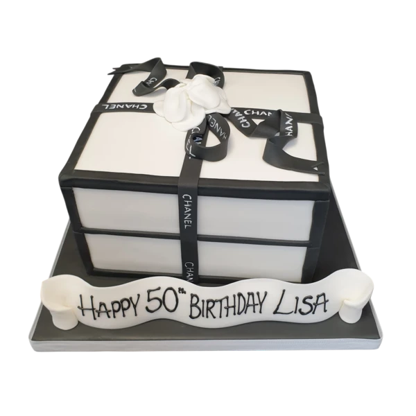 Bespoke Chanel box cake with black and white detailing, gold accents, and a Solihull, West Midlands celebration design.