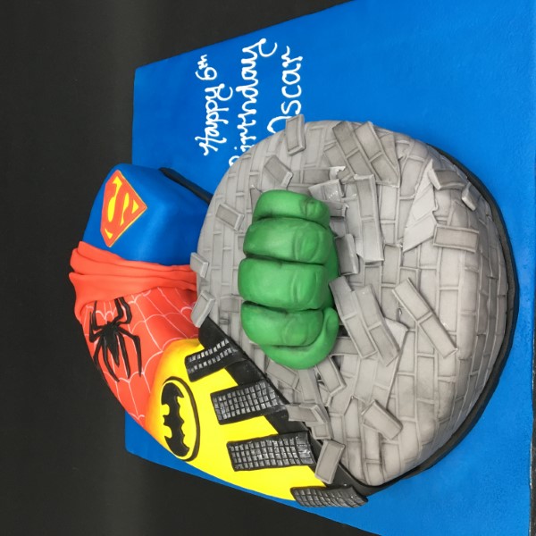 Bespoke Marvel superhero number cake with vibrant comic designs, crafted for celebration in Solihull, West Midlands.