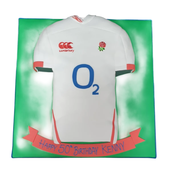 A white rugby shirt-themed cake with red and navy blue accents, perfect for fans of England's rugby team.