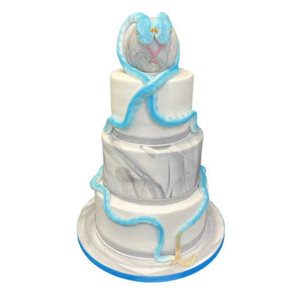 Four-tiered wedding cake with blue serpents and marble textures.