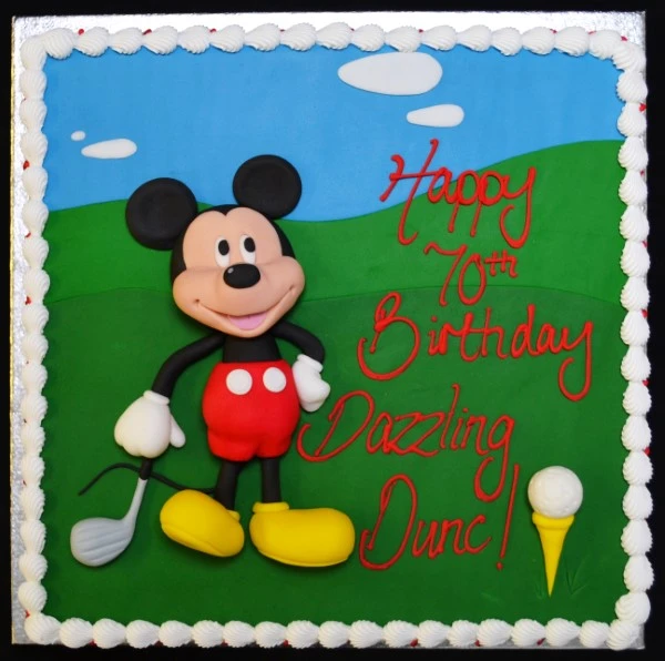 Unique Mickey Mouse golfer themed cake, featuring a square design. Perfect for fans of the iconic character looking for a special cake for an event or celebration.