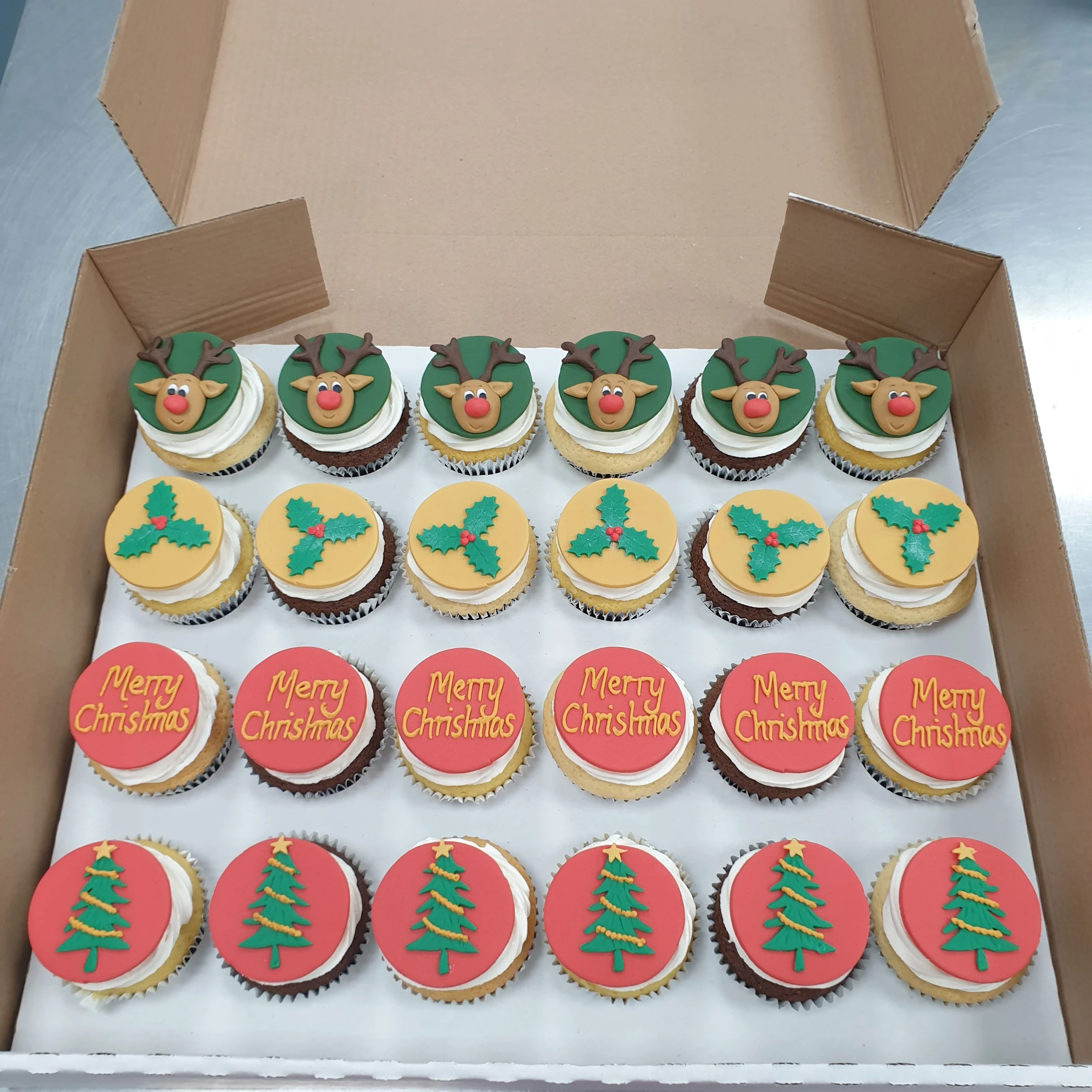 Festive bespoke Christmas cupcakes with red and green icing, holly decorations, in Solihull, West Midlands.