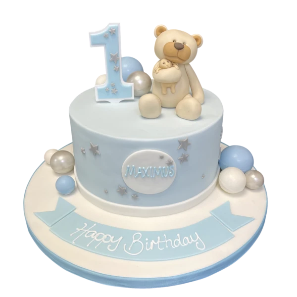 A cute and whimsical teddy bear cake with decorative balls on top, perfect for parties and special occasions. Ideal for bear lovers and fans of unique cake designs.