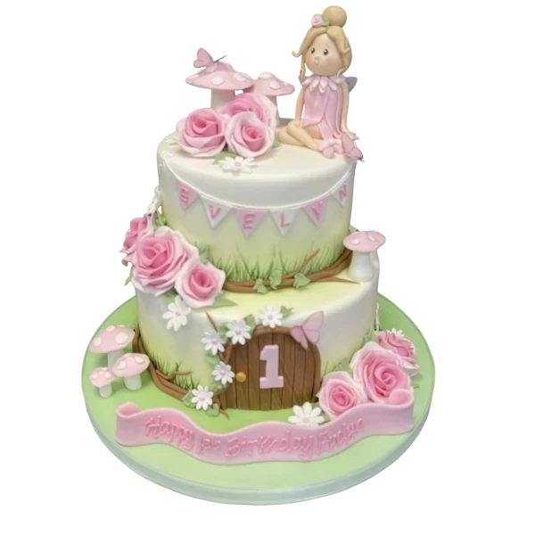 Bespoke celebration cake in Solihull, West Midlands featuring a fairy figurine surrounded by colorful sugar flowers.