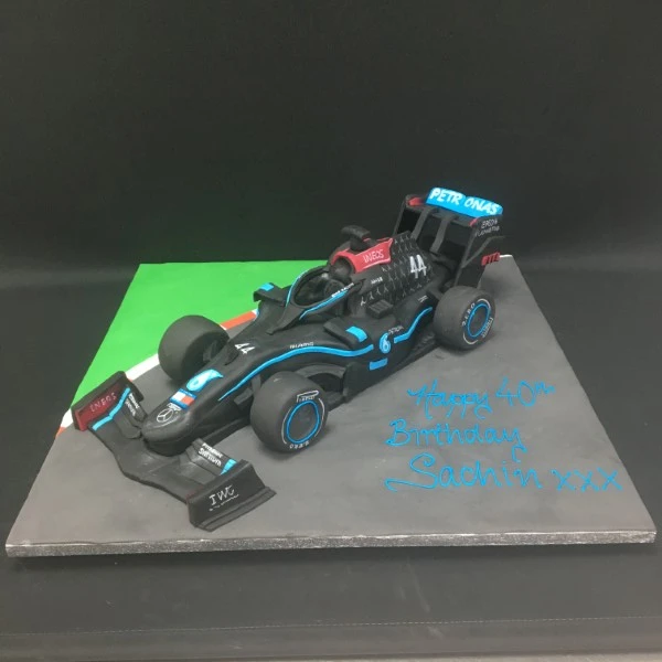Show-stopping F1 car Mercedes Hamilton inspired cake, perfect for motorsport enthusiasts. Handcrafted with intricate detailing, sure to impress at any celebration.