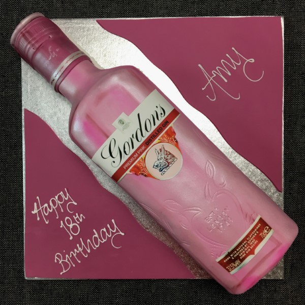 Gourmet pink gin-infused cake with elegant decorations, perfect for special occasions and celebrations.