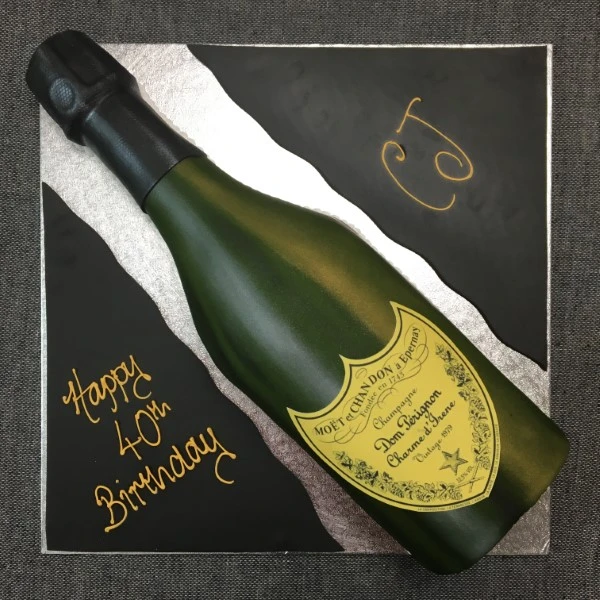 Bespoke cake shaped like a Dom Perignon bottle with detailed label, crafted for celebration in Solihull, West Midlands.
