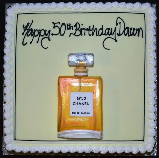 Bespoke Chanel No.5 themed cake with elegant black and gold detailing, crafted in Solihull, West Midlands.