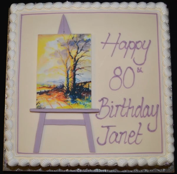 Square cake with an artist's easel design, perfect for creative celebrations.