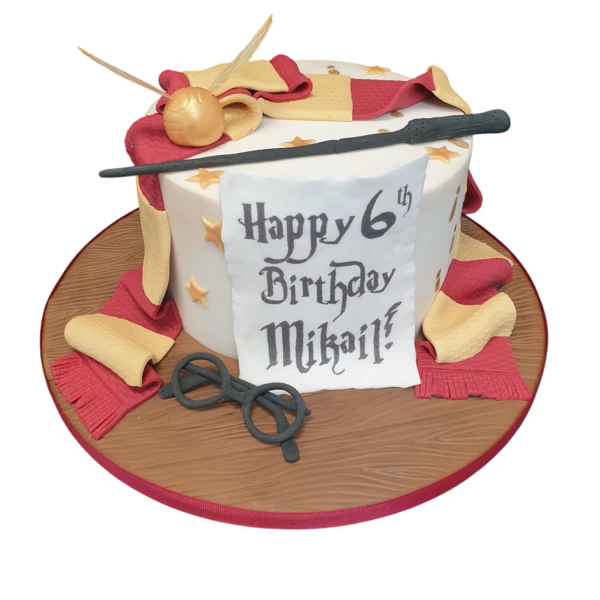 A magical Harry Potter themed cake decorated with iconic symbols from the wizarding world, perfect for fans of the beloved book and film series.