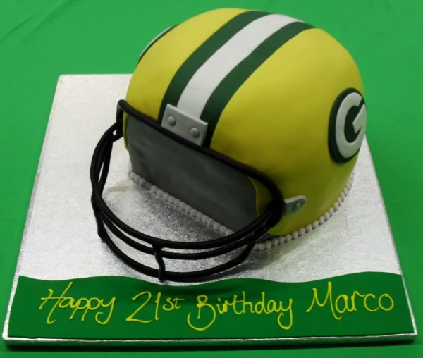 Bespoke American football helmet cake with detailed team logo, displayed for celebration in Solihull, West Midlands.
