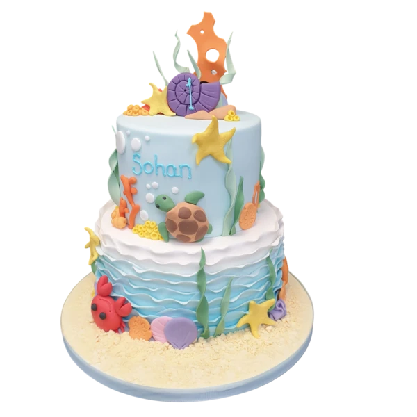 Bespoke under the sea celebration cake with colorful coral and marine life decorations, Solihull, West Midlands.