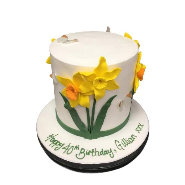 Bespoke celebration cake decorated with detailed yellow daffodils, crafted in Solihull, West Midlands.