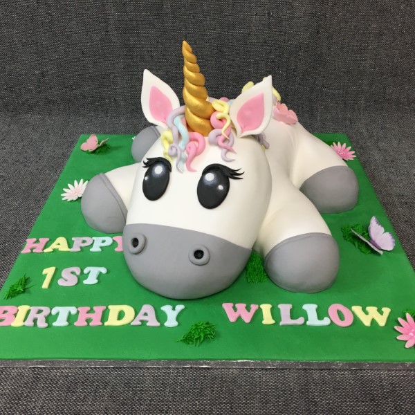 Bespoke unicorn-themed celebration cake with pastel colors and a golden horn in Solihull, West Midlands.