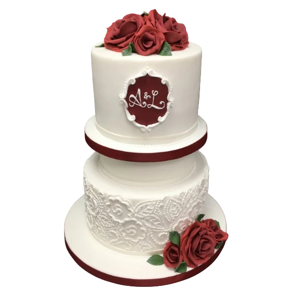 Three-tier wedding cake with crimson roses, lace details, and personalised monogram.