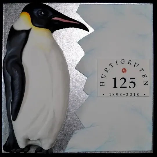 Bespoke Emperor Penguin cake with detailed black and white icing, crafted for celebration in Solihull, West Midlands.