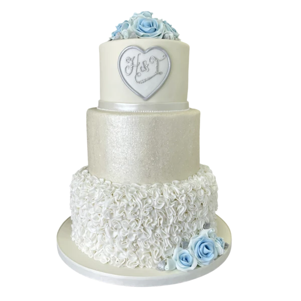 Three-tier wedding cake with sugar paste roses and elegant textured designs.