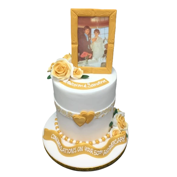 Beautiful anniversary cake decorated with delicate rose flowers and an elegant frame design, perfect for celebrating love and commitment.