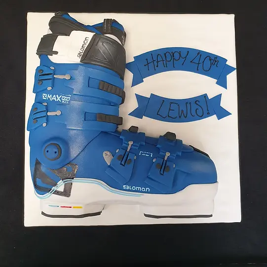 Bespoke ski boot cake with detailed laces and tread design, crafted in Solihull, West Midlands for celebration.