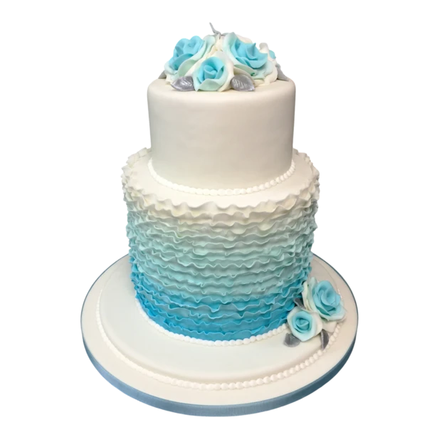 Two-tier wedding cake with blue roses and ruffled sugar paste design.