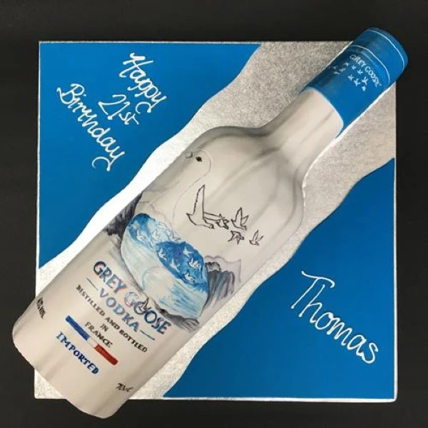 Luxury Grey Goose bottle-shaped cake for special celebrations, topped with elegant details and perfect for spirits enthusiasts.