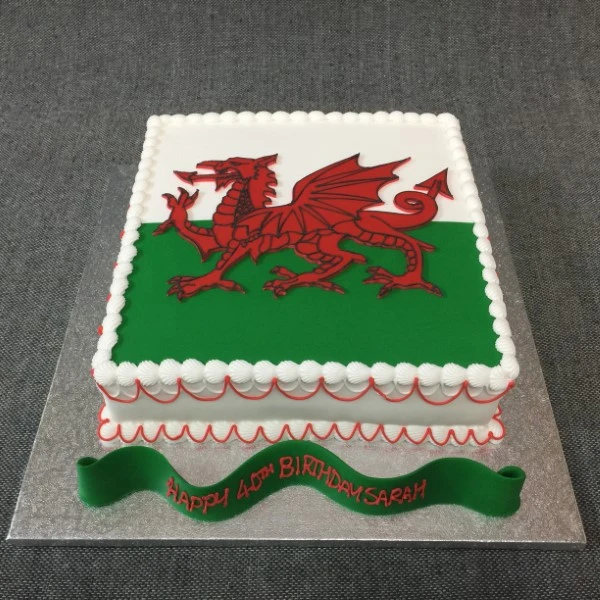 Beautiful and intricately designed cake inspired by the Welsh flag, perfect for celebrating special occasions.