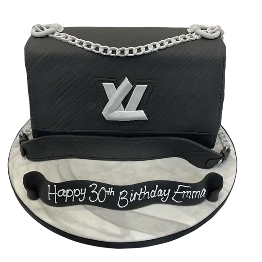 Bespoke cake shaped like a Louis Vuitton handbag with signature monogram pattern, crafted in Solihull, West Midlands.