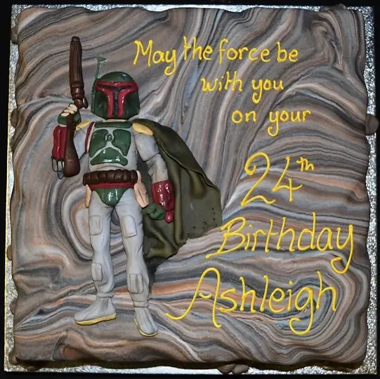 Bespoke Mandalorian-themed celebration cake with detailed helmet design, crafted in Solihull, West Midlands.