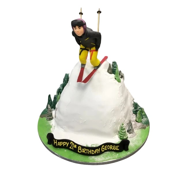 Bespoke cake shaped like a skier in action, decorated with snowy details, crafted in Solihull, West Midlands.