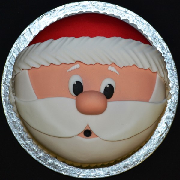 Bespoke Santa-themed cake with red and white icing details, perfect for celebration in Solihull, West Midlands.