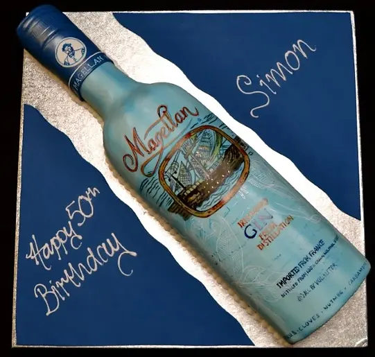 Bespoke cake shaped like a Magellan gin bottle with detailed label, crafted for celebration in Solihull, West Midlands.