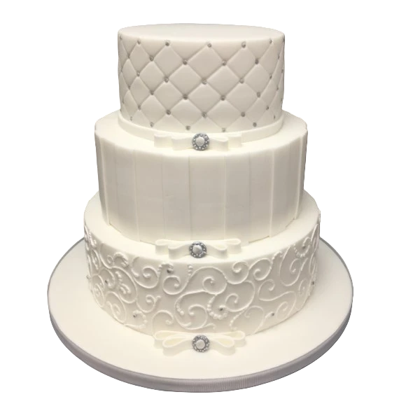 Three-tier wedding cake with quilted, striped, and swirling sugar paste designs.